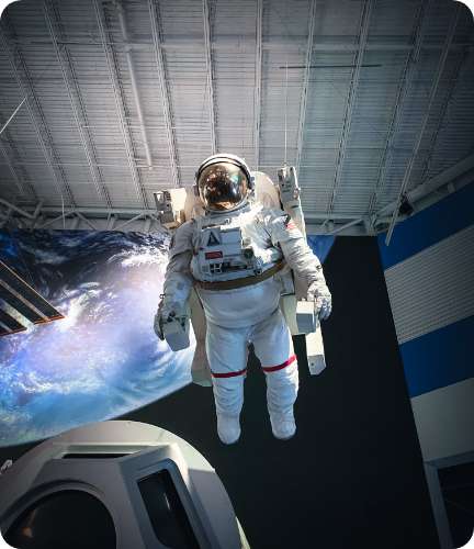 Astronaut floating in space outside a spacecraft with Earth in the background to represent GETS’ DLA Lab Approval.