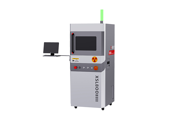 A grey industrial X-ray machine for inspecting electronic components with a black screen and red and yellow warning labels.