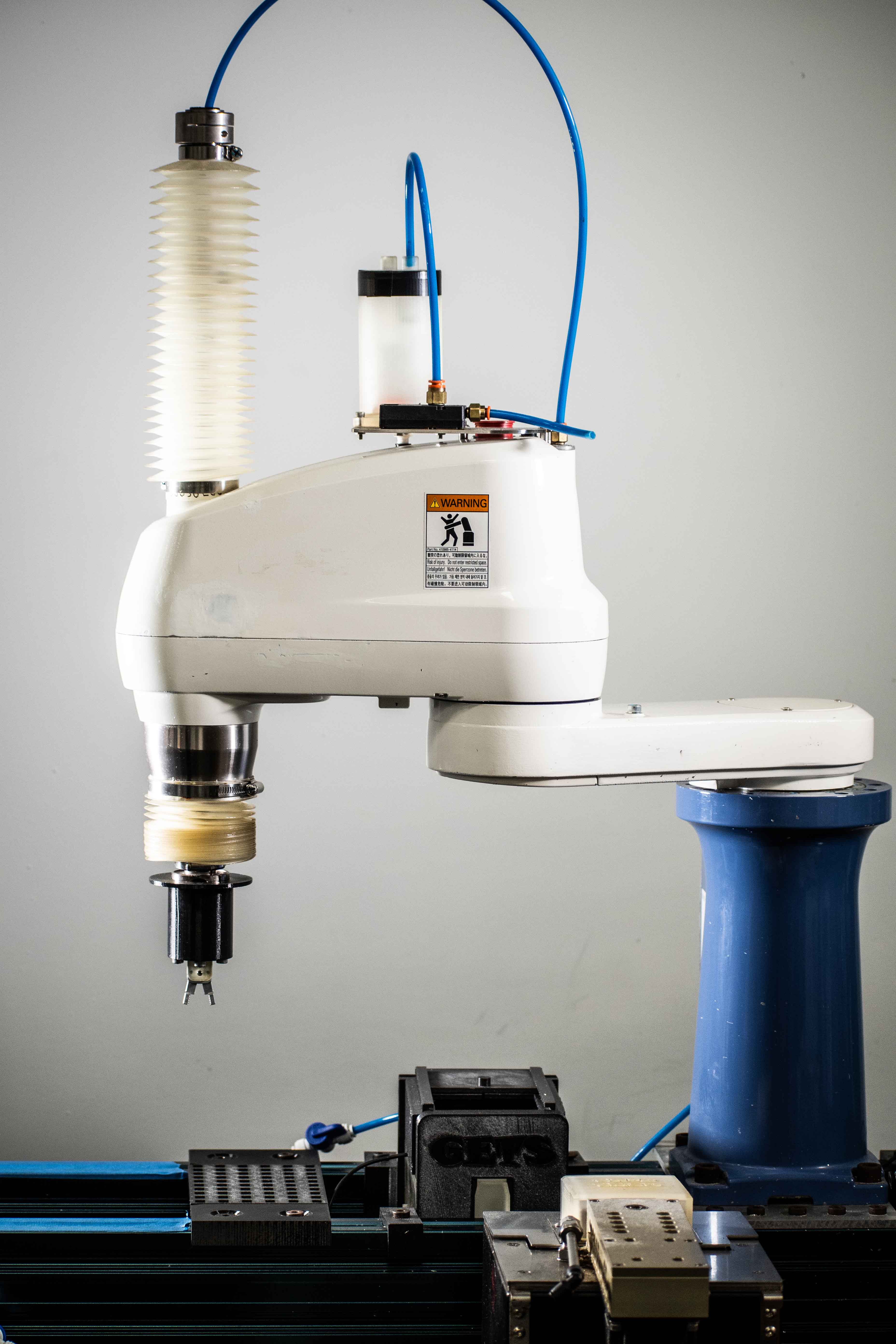 Close-up of Global ETS’ automated semiconductor re-tinning machine, surrounded by various equipment and cables. 